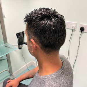 Man in a Stockport salon getting a hair replacement unit fitted