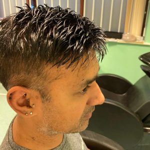 Man with a hair replacement unit getting a haircut in a Manchester salon