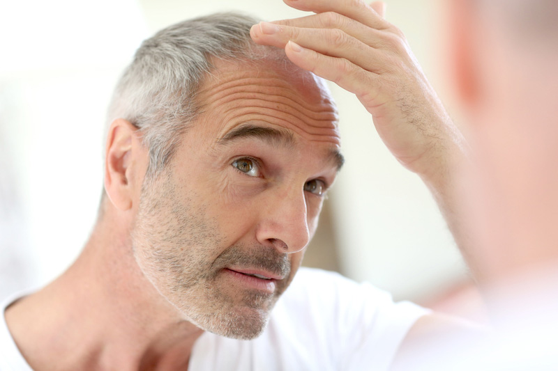 Older man checking for hair loss