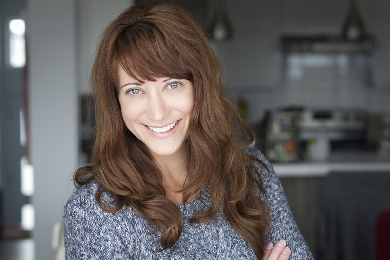 Young happy woman with brown hair and a fringe